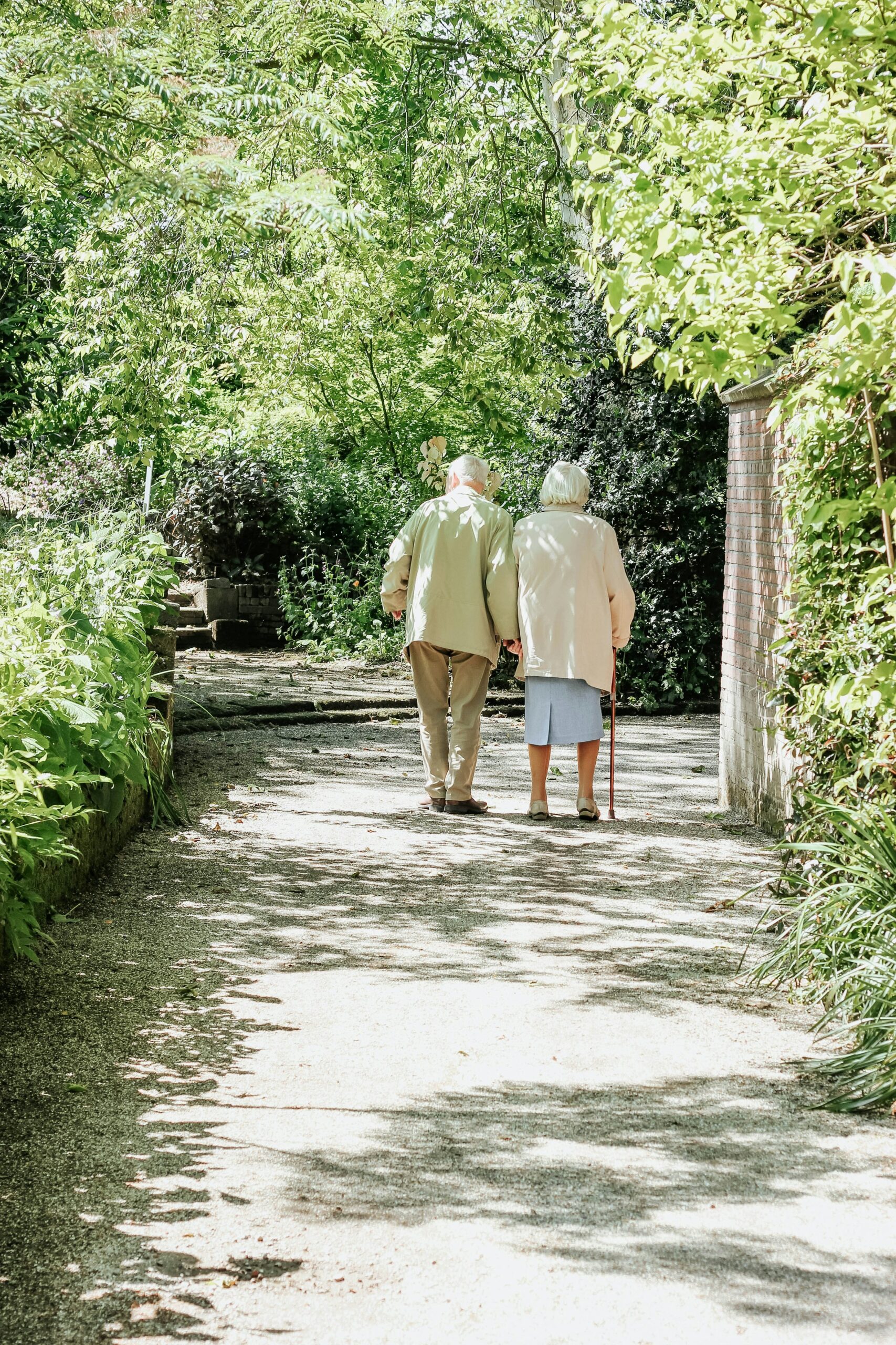 Two older adults walking in the park